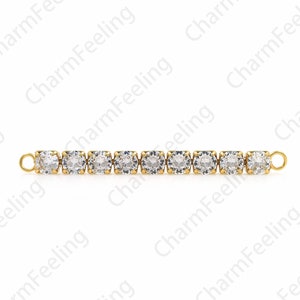 May include: A gold chain with clear round rhinestones. The chain has two clasps on either end.