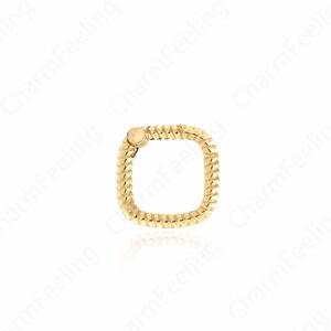 May include: A gold square charm with a twisted rope design.