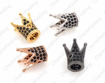 May include: Four crown-shaped metal beads with black cubic zirconia stones. The beads are in gold, rose gold, silver, and black.