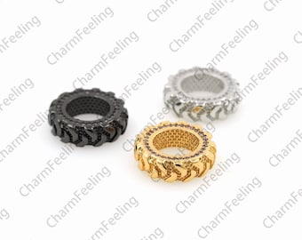 May include: Three metal rings with a tire tread design. The rings are gold, silver, and black.