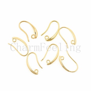 May include: Gold-toned earring hooks, also known as French hooks, are a popular choice for jewelry making. These hooks are made of metal and have a smooth, polished finish. They are designed to be durable and easy to use.