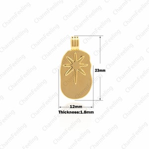 May include: Gold pendant charm with a starburst design. The pendant is 1.8 mm thick, 12 mm wide, and 23 mm tall.