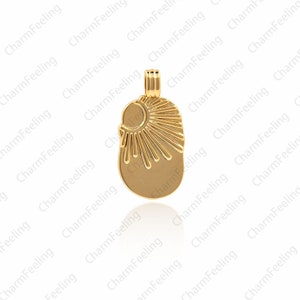 May include: A gold-toned pendant charm featuring a sunburst design with a crescent moon shape at the top. The charm is oval-shaped and has a smooth, polished finish.