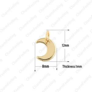 May include: Gold-toned crescent moon charm with a jump ring. The charm is 8mm wide and 12mm tall. The thickness is 1mm.