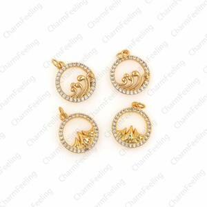 May include: Four gold-tone metal charms with clear rhinestone accents. Two charms feature a wave design and two charms feature a mountain design.