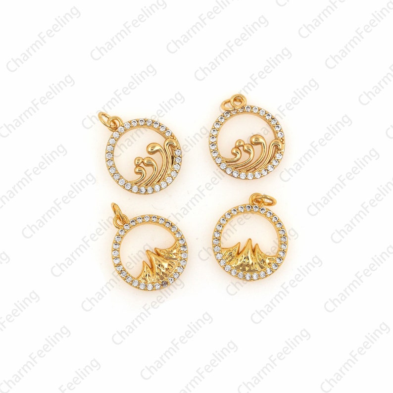 May include: Four gold-tone metal charms with clear rhinestone accents. Two charms feature a wave design and two charms feature a mountain design.
