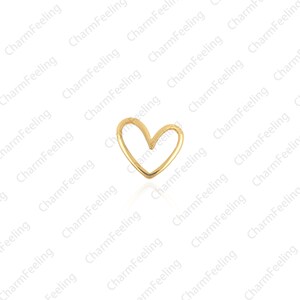 May include: A gold-colored heart-shaped charm. The charm is a simple, open heart design.