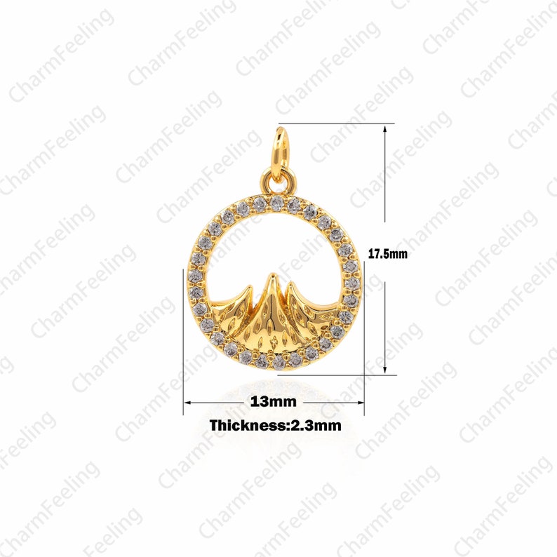May include: Gold pendant charm featuring a mountain range design with clear cubic zirconia stones around the perimeter. The pendant is 13mm in diameter and 23mm thick.