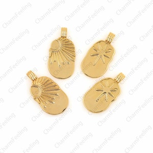 May include: Four gold-toned metal charms with different designs. Two charms feature a sun with rays, and two charms feature a starburst.