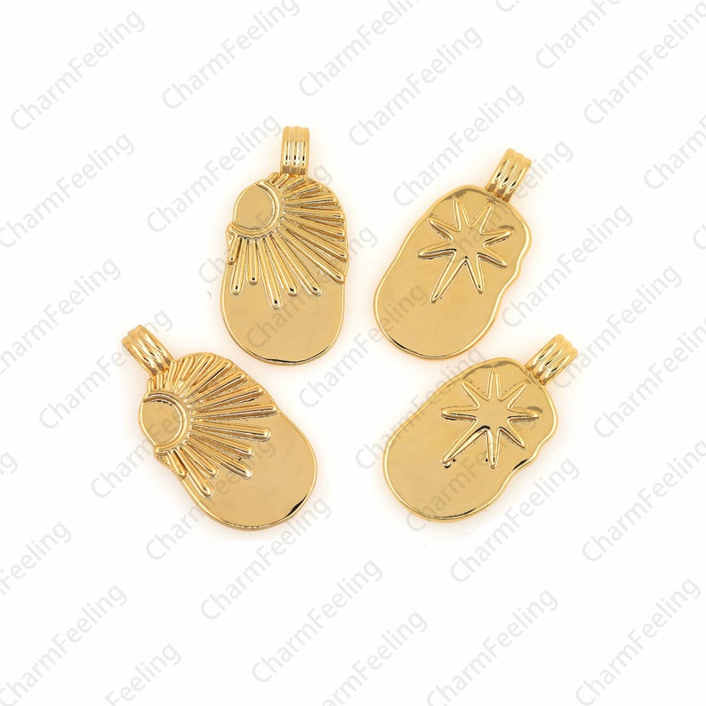 May include: Four gold-toned metal charms with different designs. Two charms feature a sun with rays, and two charms feature a starburst.