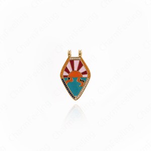 May include: A gold-colored pendant with a colorful sunrise design. The pendant features a diamond shape with a red, orange, and pink sun over blue water. The edges are lined with small, sparkling stones.