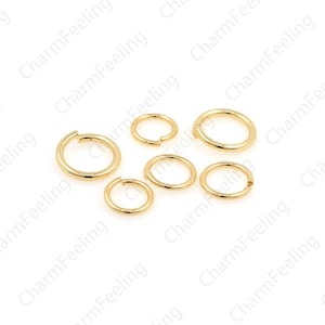May include: A set of six gold jump rings of varying sizes. The jump rings are made of metal and are used for connecting jewelry pieces.