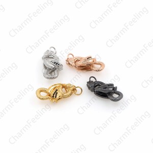 May include: Four dragon-shaped clasps in different finishes: silver, gold, rose gold, and black. Each clasp features a detailed dragon design with wings and a tail.