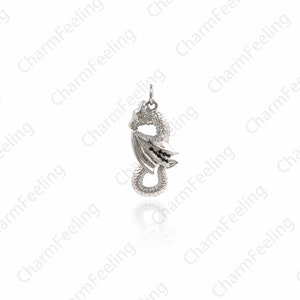 May include: Silver dragon pendant with black accents. The dragon is curled up with its wings spread out.