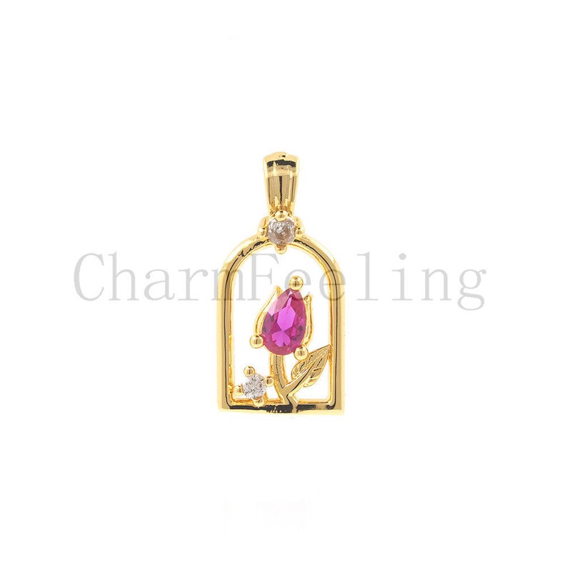 May include: Gold-tone pendant charm featuring a pink rose with clear crystal accents inside a gold-tone frame.