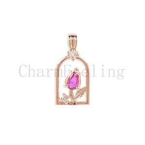 May include: A rose gold pendant featuring a pink gemstone rose inside a cage-like frame with small clear gemstones.