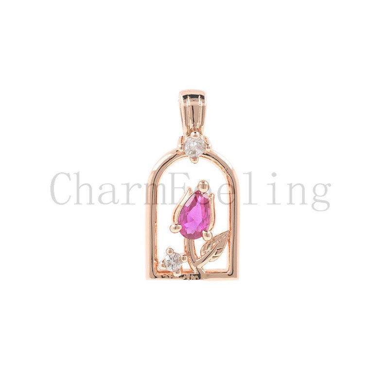 May include: A rose gold pendant featuring a pink gemstone rose inside a cage-like frame with small clear gemstones.