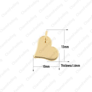 May include: Gold heart-shaped charm with a hole at the top for attaching to a necklace or bracelet. The charm measures 13 mm in height and 10 mm in width. The thickness is 1.6 mm.