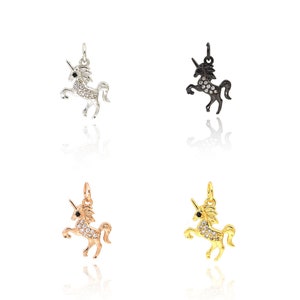 May include: Four unicorn charms in different colors: silver, black, rose gold, and gold. Each charm is adorned with sparkling clear rhinestones.