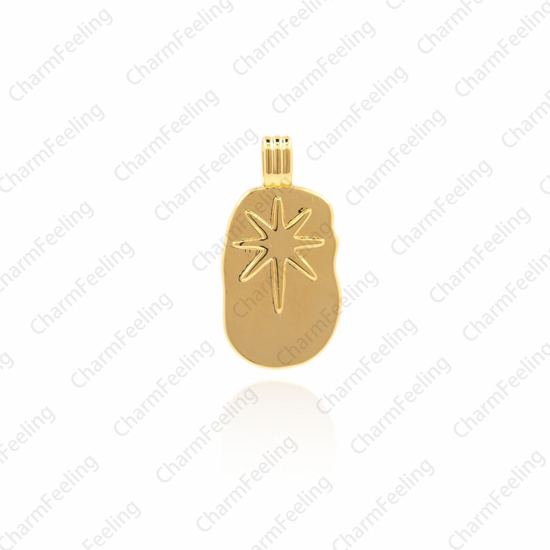 May include: Gold-toned pendant charm featuring a starburst design. The charm is shaped like a slightly irregular oval.