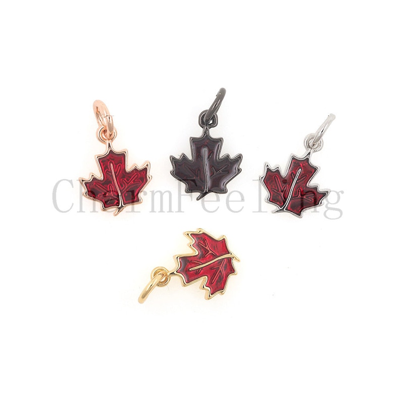 May include: Four charms in the shape of a red maple leaf. The charms are made of metal and have a shiny finish. The charms are available in gold, silver, rose gold, and black.
