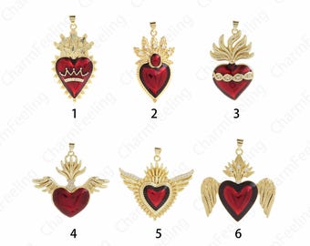 May include: Six gold-tone pendants featuring a red heart with a crown, flames, and wings. The pendants are numbered 1 through 6.