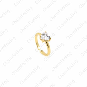 May include: A gold ring with a clear heart-shaped stone.