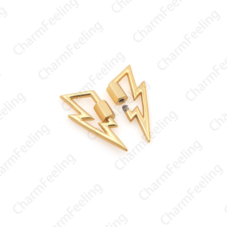 May include: Two gold-colored lightning bolt-shaped earrings. One earring is intact, while the other is disassembled, showing the screw mechanism. The earrings are set against a white background.