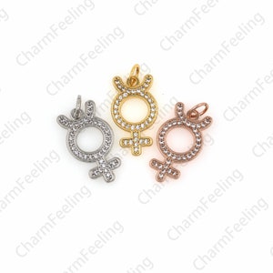 May include: Three charm pendants in gold, silver, and rose gold, each featuring a female symbol with a circle of clear cubic zirconia stones.