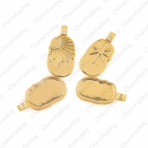 May include: Five gold-colored metal charms with different designs. The charms are shaped like irregular ovals and have a loop at the top for attaching to a necklace or bracelet. The designs include a sun with rays, a star, and three blank charms.