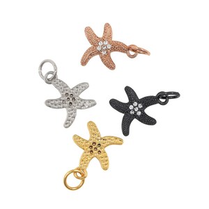 May include: Four silver starfish charms with clear rhinestones. Each charm has a loop for attaching to a bracelet or necklace.