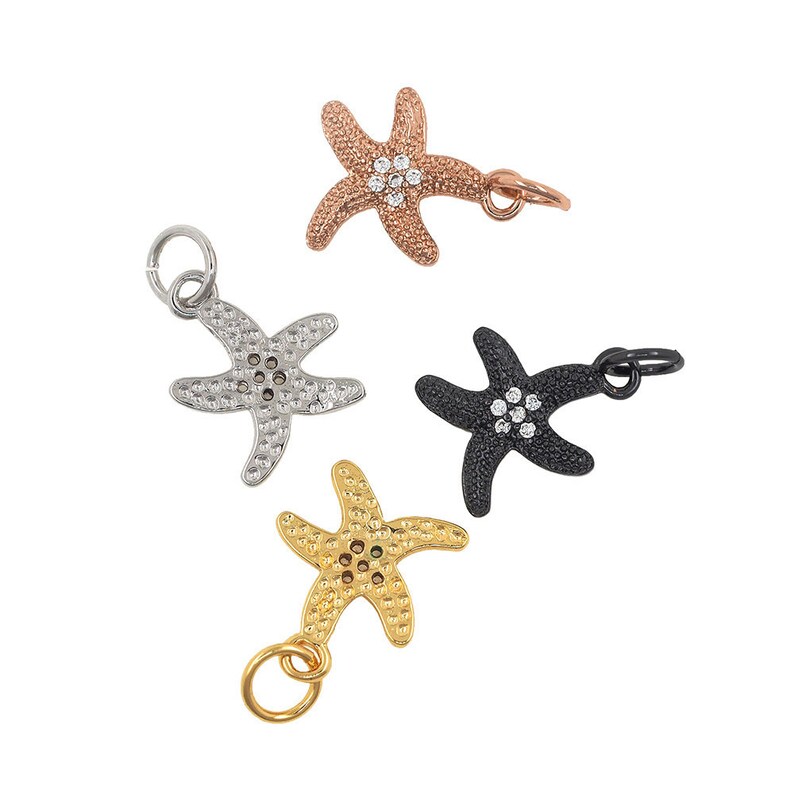 May include: Four silver starfish charms with clear rhinestones. Each charm has a loop for attaching to a bracelet or necklace.