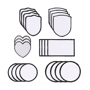 May include: A selection of blank white patches in diverse shapes: shields, hearts, rectangles, and circles. Each patch features a black border. The patches are arranged in small stacks, suitable for personalisation.