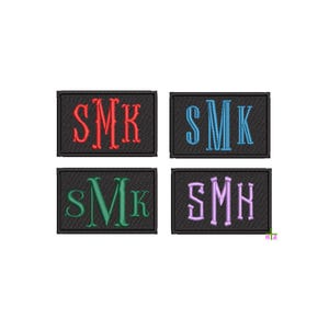 May include: Four embroidered patches with the letters SMK or SMH in various colors: red, blue, green, and purple. Each patch is rectangular with a black background and a decorative font.