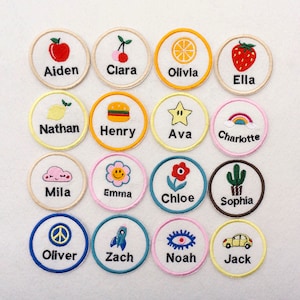 May include: Set of 16 colourful embroidered iron-on patches with various designs and names, including Aiden, Clara, Olivia, Ella, Nathan, Henry, Ava, Charlotte, Mila, Emma, Chloe, Sophia, Oliver, Zach, Noah, and Jack.