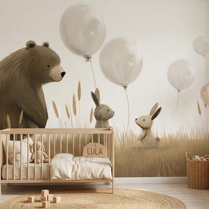 May include: A nursery room featuring a wall mural of a brown bear and two rabbits in a field of tall grass with floating white balloons. A light wood cot with a white blanket and a wooden sign reading LULA sits in front of the mural.