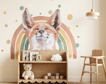 May include: A wall decal featuring a watercolor illustration of a fox head centered above a multi-colored rainbow arch with scattered circular dots in shades of green, orange, and tan, positioned above a wooden bookshelf with books and a teddy bear.