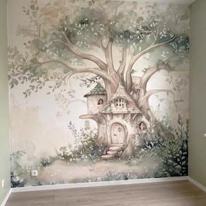 May include: A wall mural featuring a large, sprawling tree with a house built into its trunk. The illustration uses soft watercolor tones of sage green, beige, and brown, depicting a dwelling with a rounded door, small windows, and foliage.