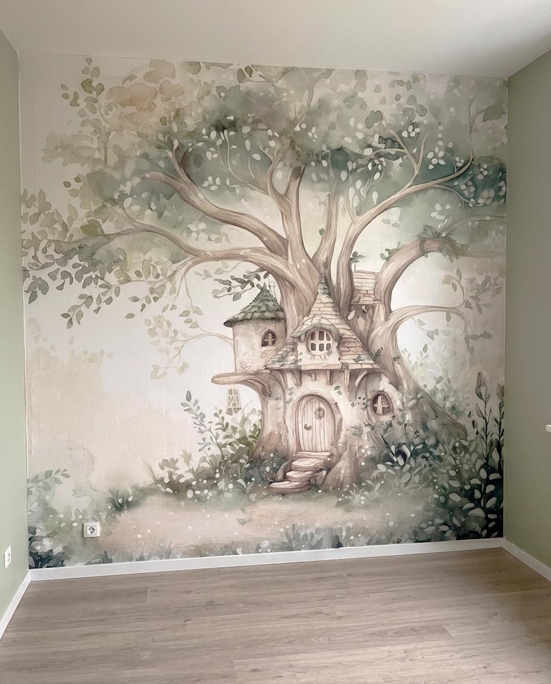 May include: A wall mural featuring a large, sprawling tree with a house built into its trunk. The illustration uses soft watercolor tones of sage green, beige, and brown, depicting a dwelling with a rounded door, small windows, and foliage.