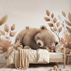 May include: A wall mural featuring a large, sleeping brown bear surrounded by illustrated autumn leaves and acorns. A wooden bed with beige bedding sits in front of the mural, with a small teddy bear resting on the mattress and a mushroom lamp.