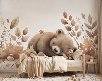May include: A wall mural featuring a large, sleeping brown bear surrounded by illustrated autumn leaves and acorns. A wooden bed with beige bedding sits in front of the mural, with a small teddy bear resting on the pillow and a mushroom lamp nearby.