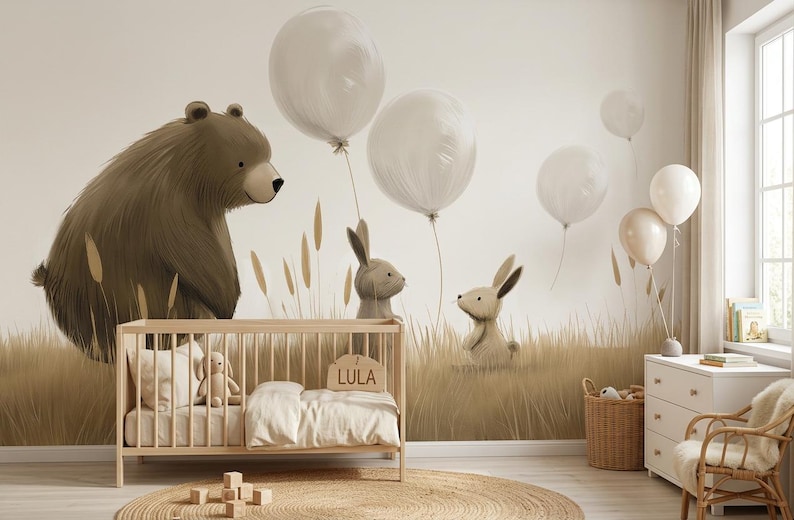 May include: A nursery room featuring a wall mural of a brown bear and two rabbits in a field of tall grass with floating white balloons. A light wood cot with a white blanket and a wooden sign reading LULA sits in front of the mural.
