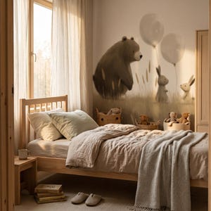 May include: A wooden bed frame with light-coloured linen bedding, a matching nightstand, and a wall mural featuring a bear and rabbits with balloons. The room includes a stack of books, a pair of slippers, and woven baskets containing plush toys.