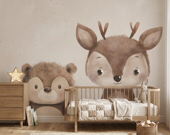 May include: A wall mural featuring a large brown bear and a deer head illustration. The room includes a wooden crib with a white quilt, a wooden dresser with a star-shaped lamp, a small stuffed rabbit, and a woven basket filled with wooden blocks.