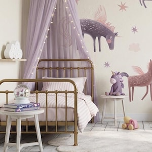 May include: A child's bedroom with a gold metal bed frame, a canopy, and unicorn-themed decor. The room features a white rug, a small side table, and a plush unicorn toy. The walls are painted a light beige with unicorn wall decals.