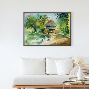 May include: Watercolor painting of a small, rustic hut with a thatched roof, surrounded by lush green trees and a pond. A person is sitting in the pond, washing clothes.