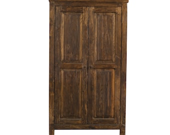 May include: A dark brown wooden armoire with two doors and a decorative top. The doors have a simple raised panel design.