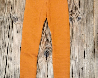 Leggings made of rib jersey in rust orange. Unisex thermal leggings trousers
