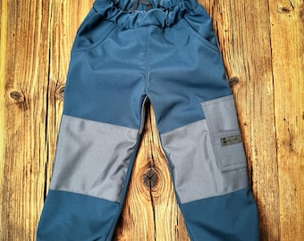 May include: Blue and gray children's pants with a patch on the right leg that says "FRECH" in white letters.