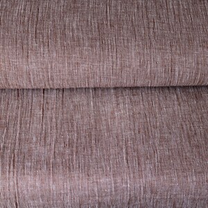 May include: Close-up of a brown fabric with a subtle white woven pattern. The fabric is folded in half, showing the texture and weave.